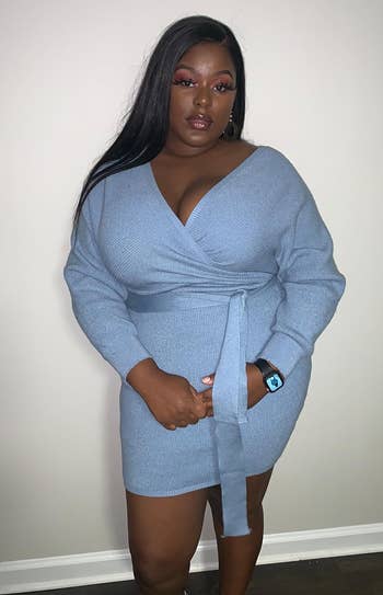 reviewer wearing the blue batwing sweater dress
