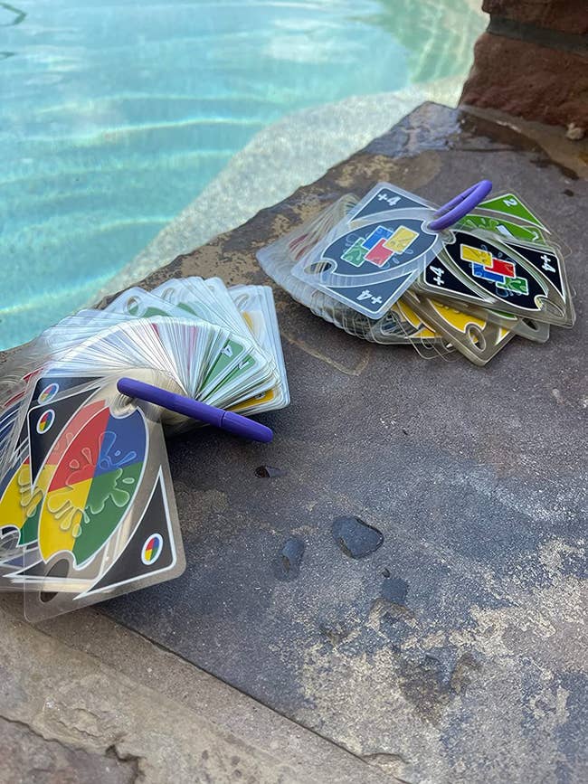reviewer's waterproof Uno cards by a pool