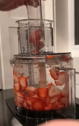 gif of reviewer using the food processor to slice strawberries