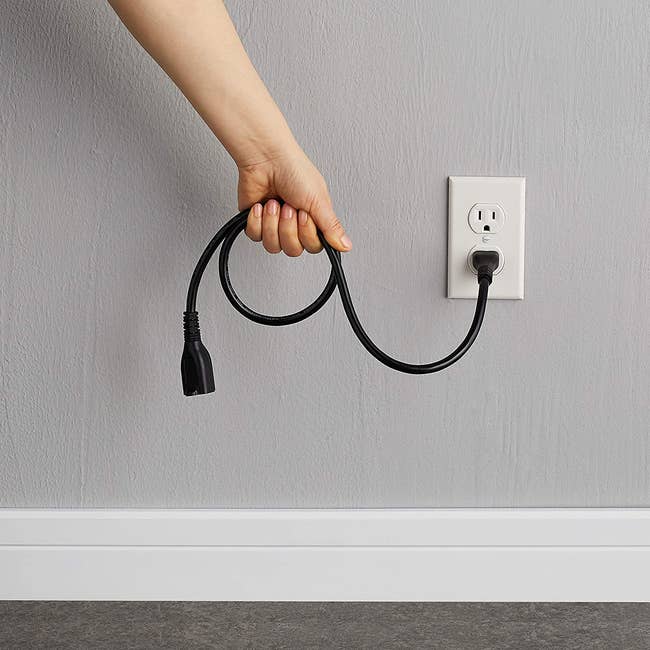 photo of a model holding the extension cord
