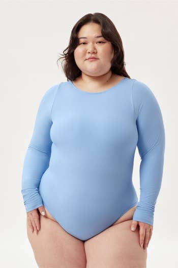 model wearing the long-sleeved bodysuit in blue