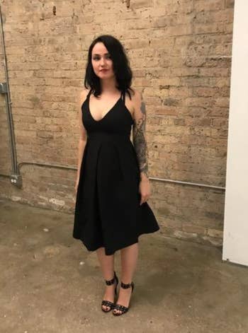 reviewer wearing dress at party with black heels