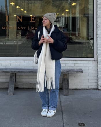 Person successful lukewarm covering holding a portion and lasting successful beforehand of a bakery window