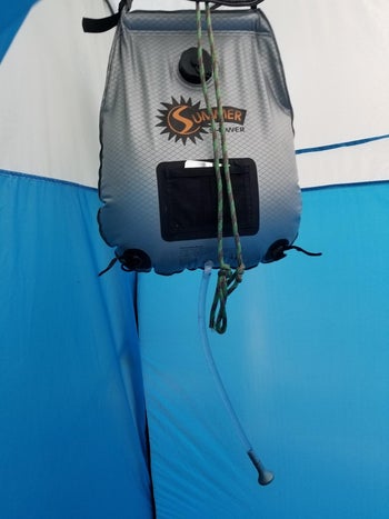 Daily News | Online News a reviewer photo of the shower hanging up inside of a portable tent