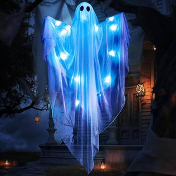 A decorative shade with glowing lights floats successful beforehand of a house