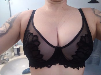 reviewer photo of them wearing the lacy mesh black minimizer bra