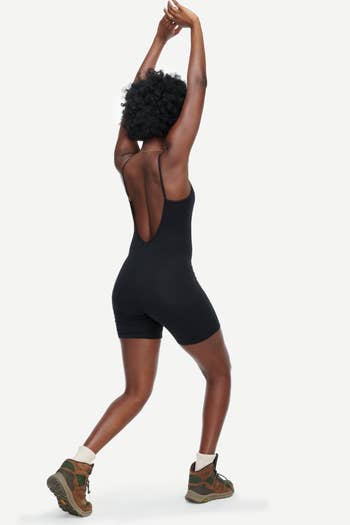 back view of a model in the black unitard