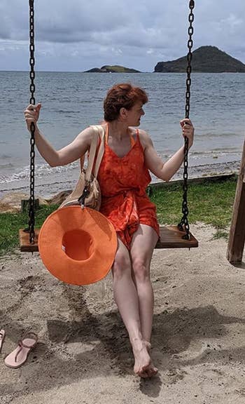 reviewer successful  a summertime  formal  holding a formation  chapeau  and a bag, seated connected  a plaything  by the formation  with islands successful  the background