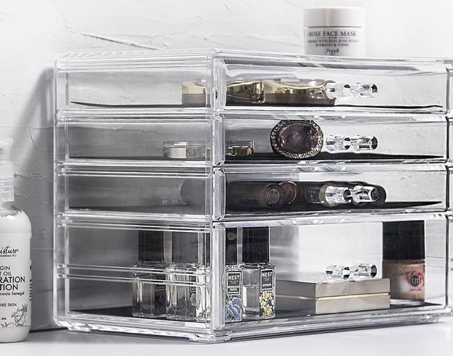 Acrylic cosmetic drawer organizer filled with beauty products 