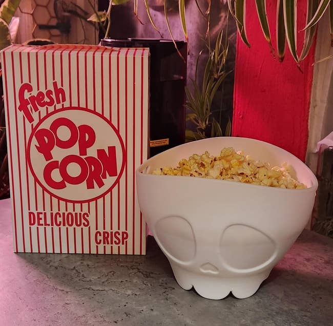 Popcorn container and skull shaped vessel connected a countertop