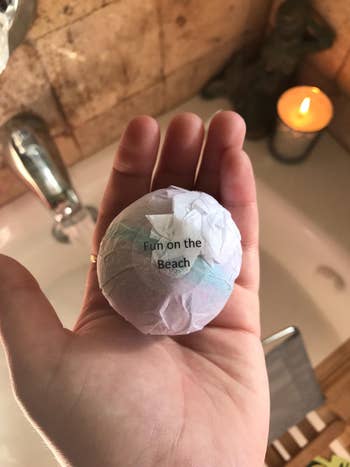 a reviewer holding a single bath bomb