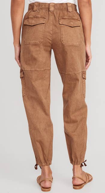 the back view of the pants in light brown showing the elastic at the waistband 