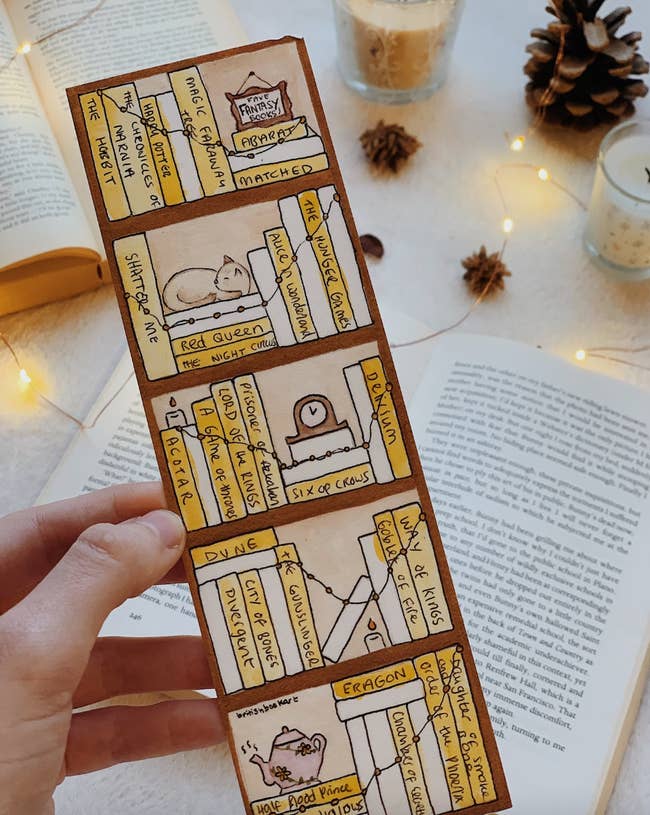 hand holding cute bookmark filled with titles of books read