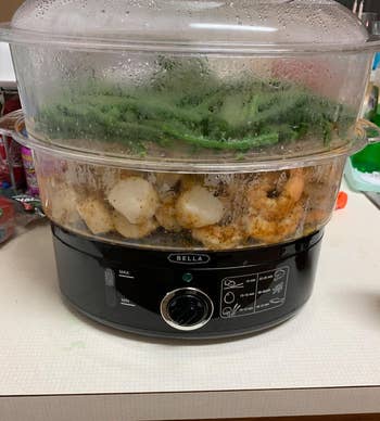 reviewer's two tier steamer with green beans and shrimp in it 