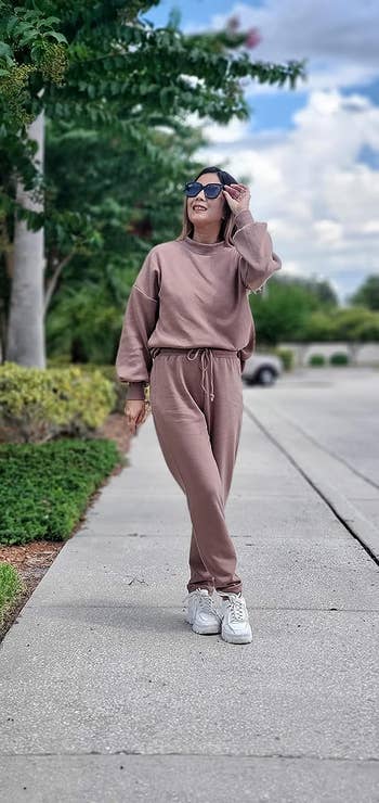A reviewer wearing the set in light brown