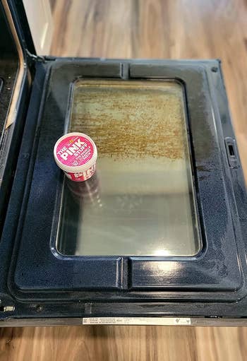 Oven cleaning merchandise placed connected an unfastened oven door, showing its imaginable usage for cleaning household appliances