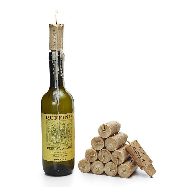 a candle in the shape of a wine cork placed onto an empty wine bottle