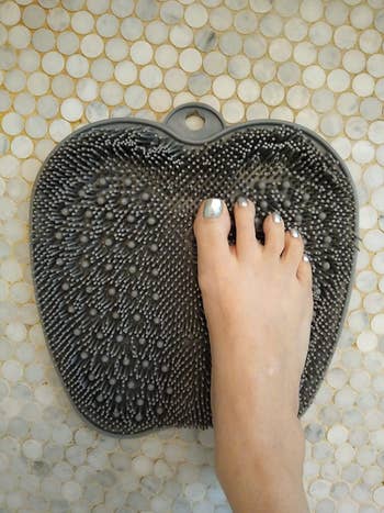 Reviewer placing foot on foot scrubber