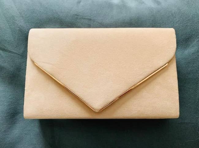a reviewer's photo of the clutch in beige