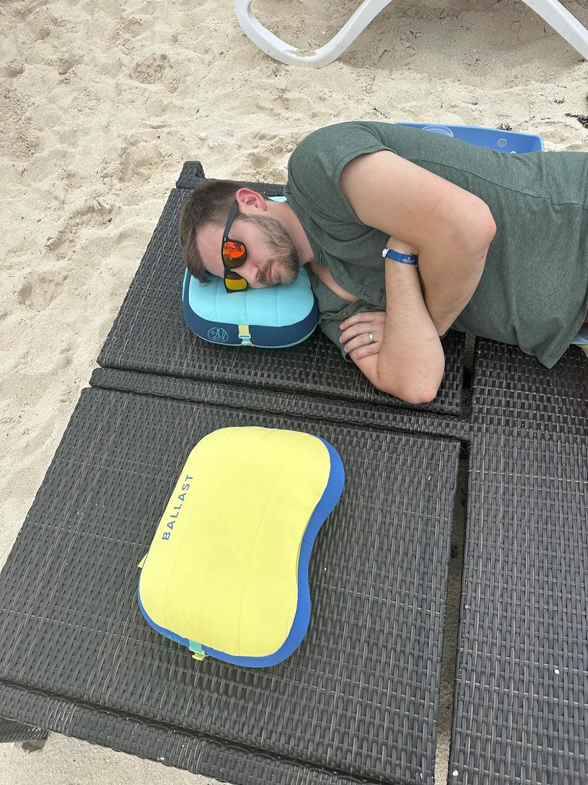 reviewer laying connected  bluish  inflatable pillow