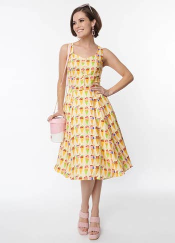 model in light yellow midi sleeveless dress with colorful ice cream cones