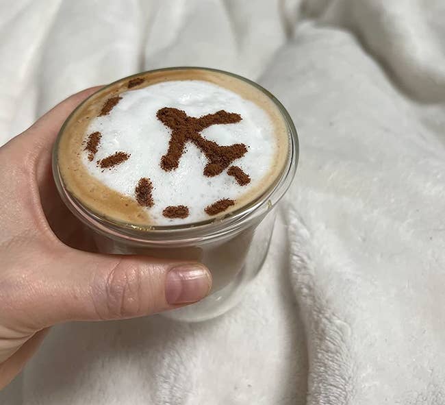 reviewer photo of their cappuccino with an airplane design on it
