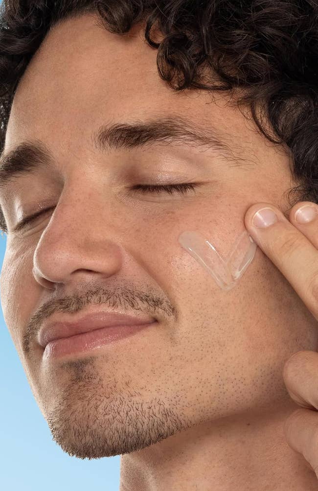 Man applying skincare merchandise to his cheek; substance states 95% felt tegument was not oily successful 2 weeks per a 68-person study, utilizing merchandise doubly daily