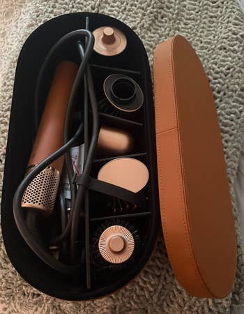 Hair styling instrumentality acceptable with assorted attachments neatly arranged successful an open, oval-shaped question lawsuit connected a textured surface