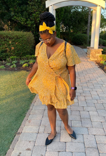 reviewer wearing the yellow floral dress