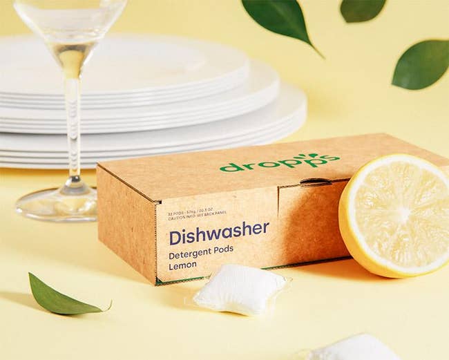 a box of the dishwasher pods next to a lemon