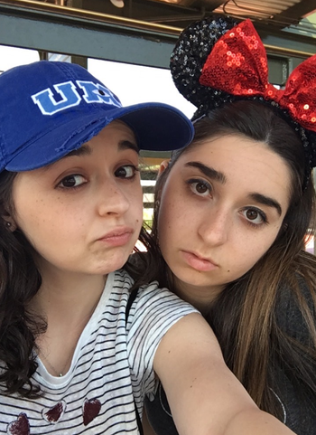 buzzfeed editor with a blue MU hat on