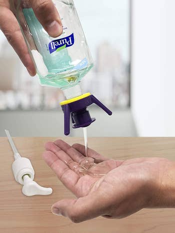 model squeezing soap from an upside down bottle fitted with one of the attachments into their hand