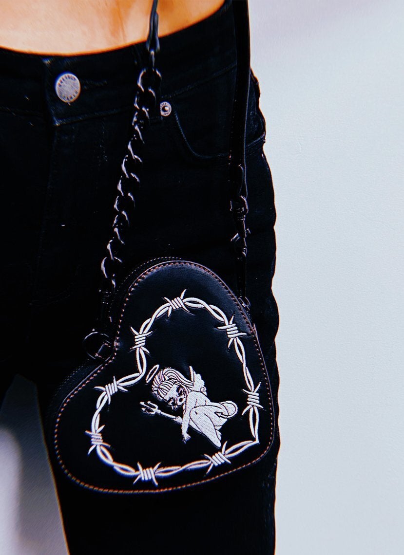 heart shaped bag with embroidered angel demon gal with barbed wire details