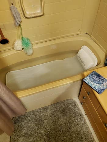 reviewer photo of the pillow, which spans the full length of the tub