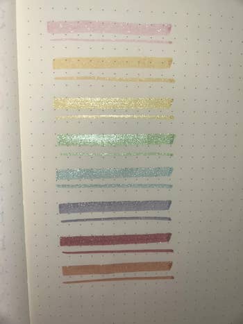 Eleven glittery pen swatches connected  dotted paper, showcasing pastel colors for imaginable   purchase