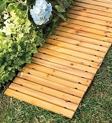 a wooden slatted walkway laid down on grass