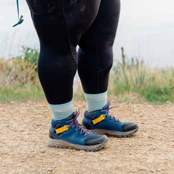 model wearing gore-tex Teva booties on a trail