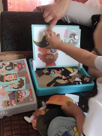 A child making a pirate face with the magnetic pieces