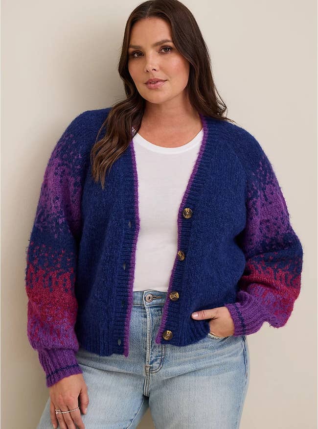 model wearing the purple and blue cardigan over a white top with jeans