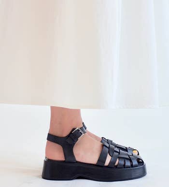 model wearing the sandals in black
