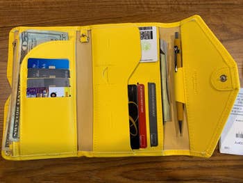 reviewer's wallet opened to show several compartments 