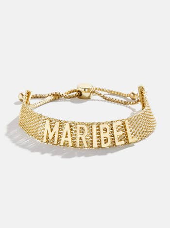 The gold mesh bracelet with adjustable closure and letters reading 