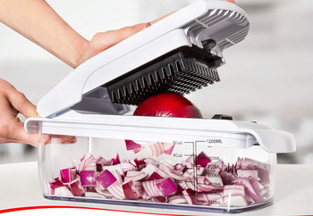 Model pressing down on top to cut an onion 