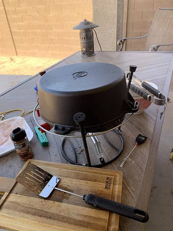 reviewer photo of camping grill set over camp stove