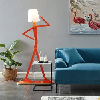 the person-like shaped floor lamp with a lamp shade where the head would be