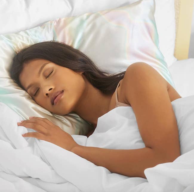 Model laying on the rainbow iridiscent pillowcase 