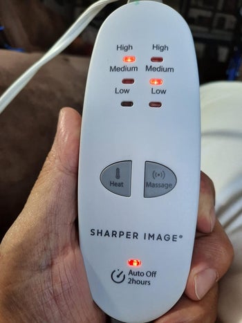 Image of reviewer holding white remote