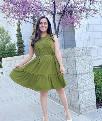 reviewer wearing army green dress