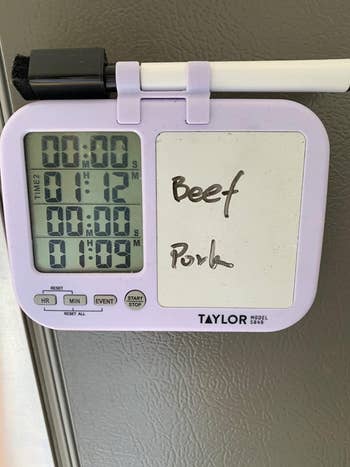 reviewer photo of the timer on a fridge with two timers set and labels for 