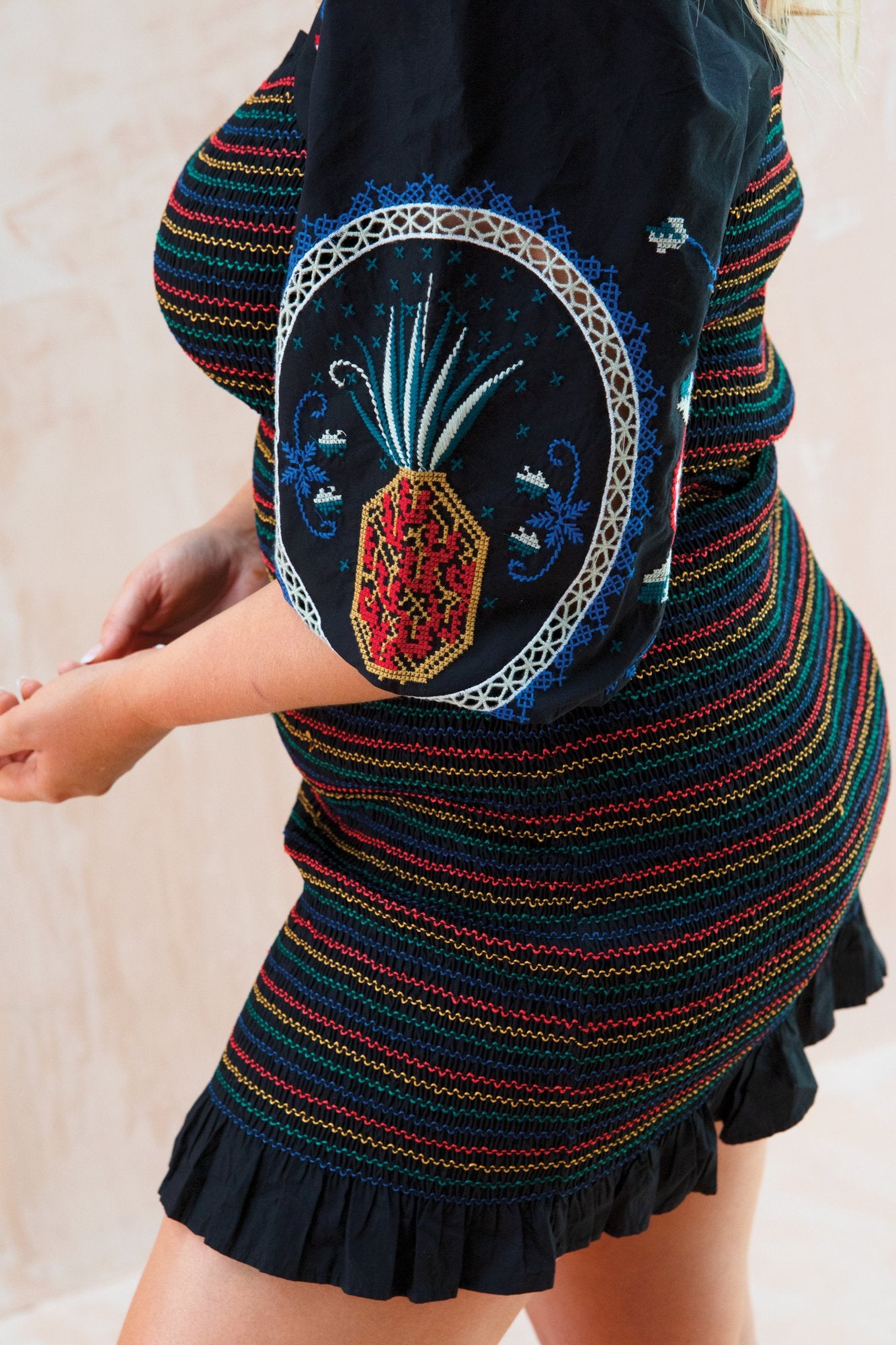 model wearing black smocked dress